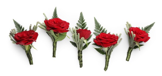 Photo of Many stylish red boutonnieres isolated on white, top view