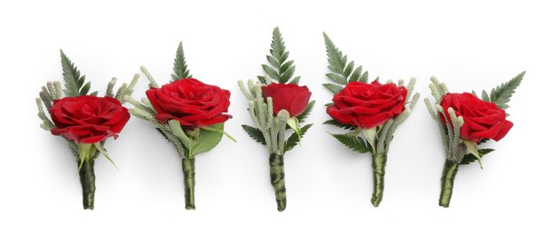 Many stylish red boutonnieres isolated on white, top view
