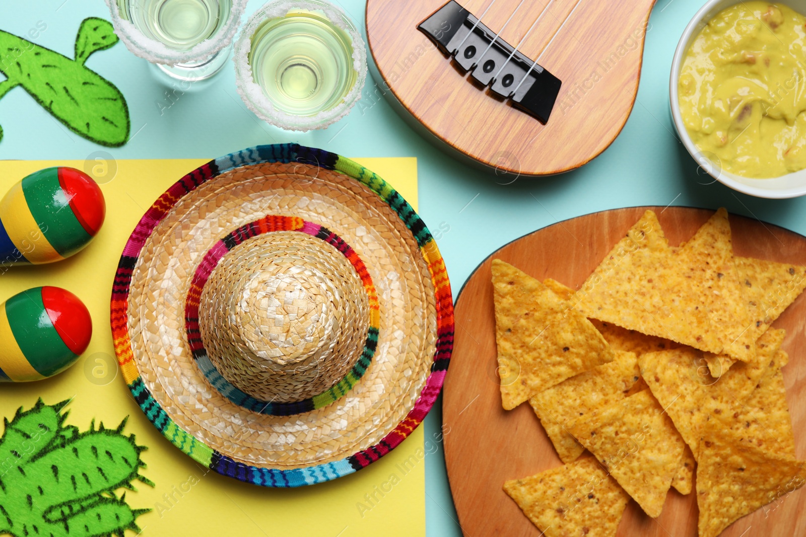 Photo of Flat lay composition with Mexican sombrero hat on color background