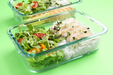 Photo of Healthy meal. Different products in glass containers on green background, closeup