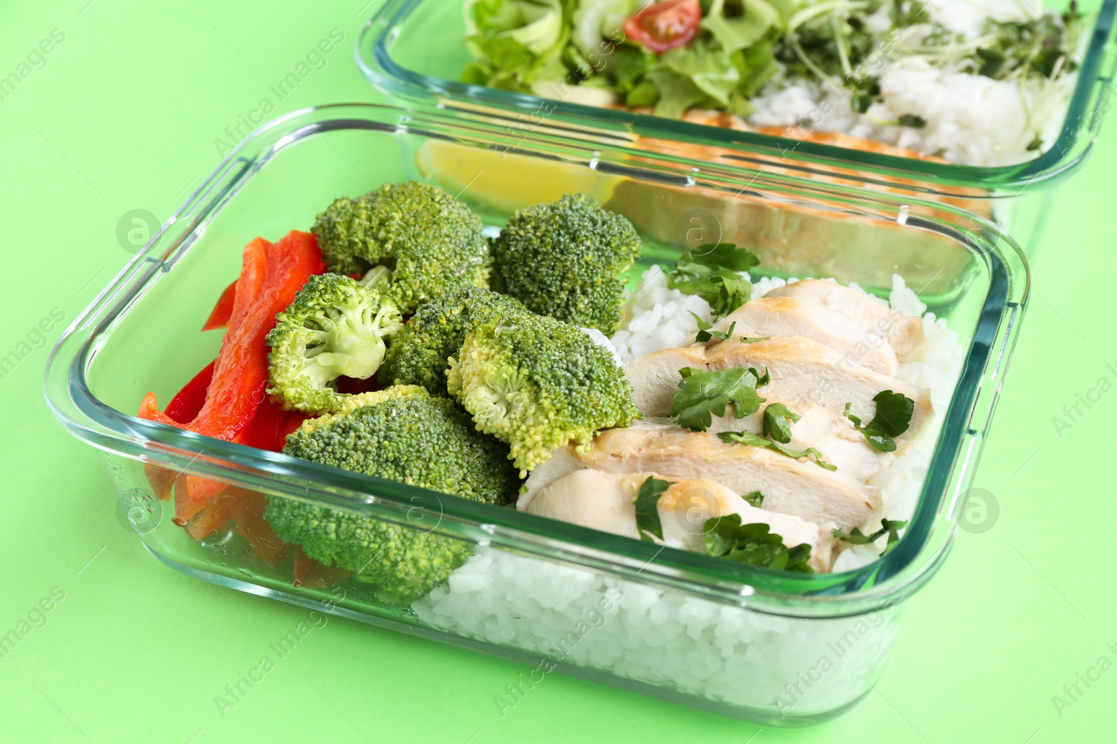 Photo of Healthy meal. Different products in glass containers on green background, closeup