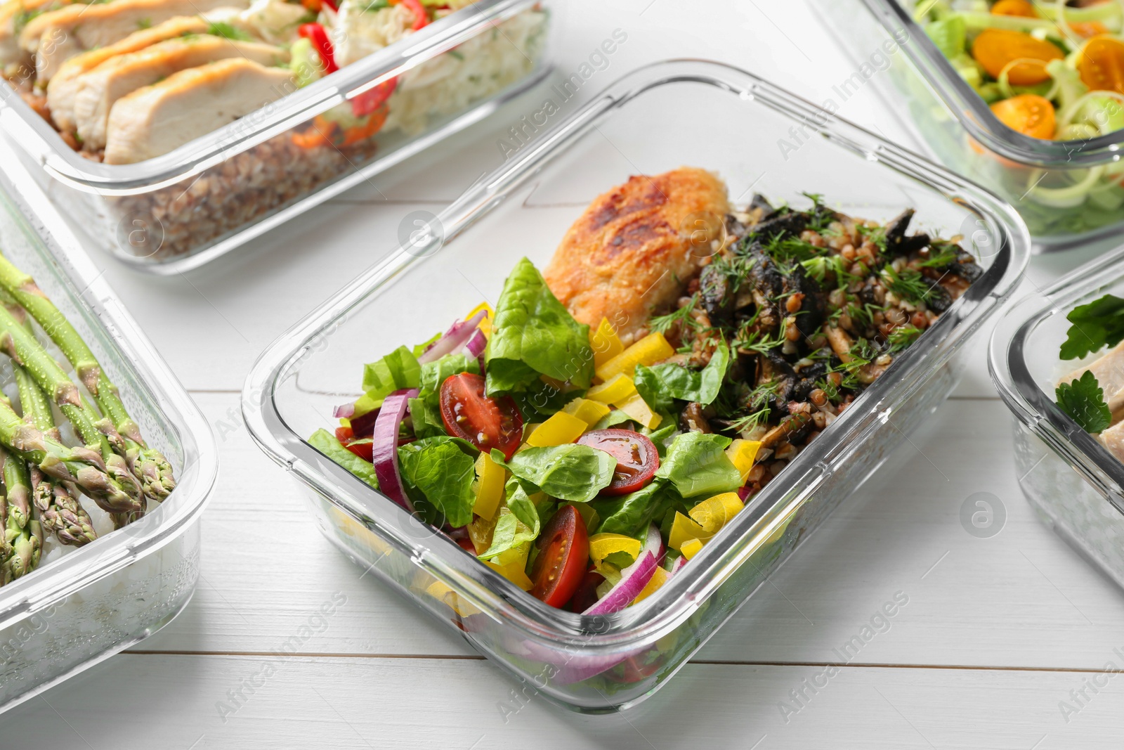 Photo of Healthy meal. Containers with different products on white wooden table