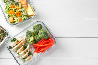 Photo of Healthy meal. Containers with different products on white wooden table, flat lay. Space for text