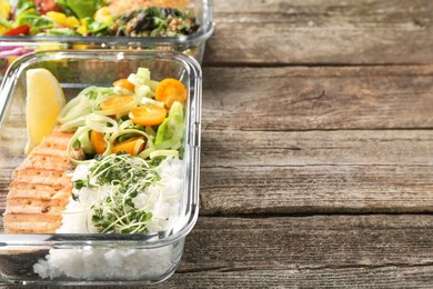 Photo of Healthy meal. Containers with different products on wooden table, closeup