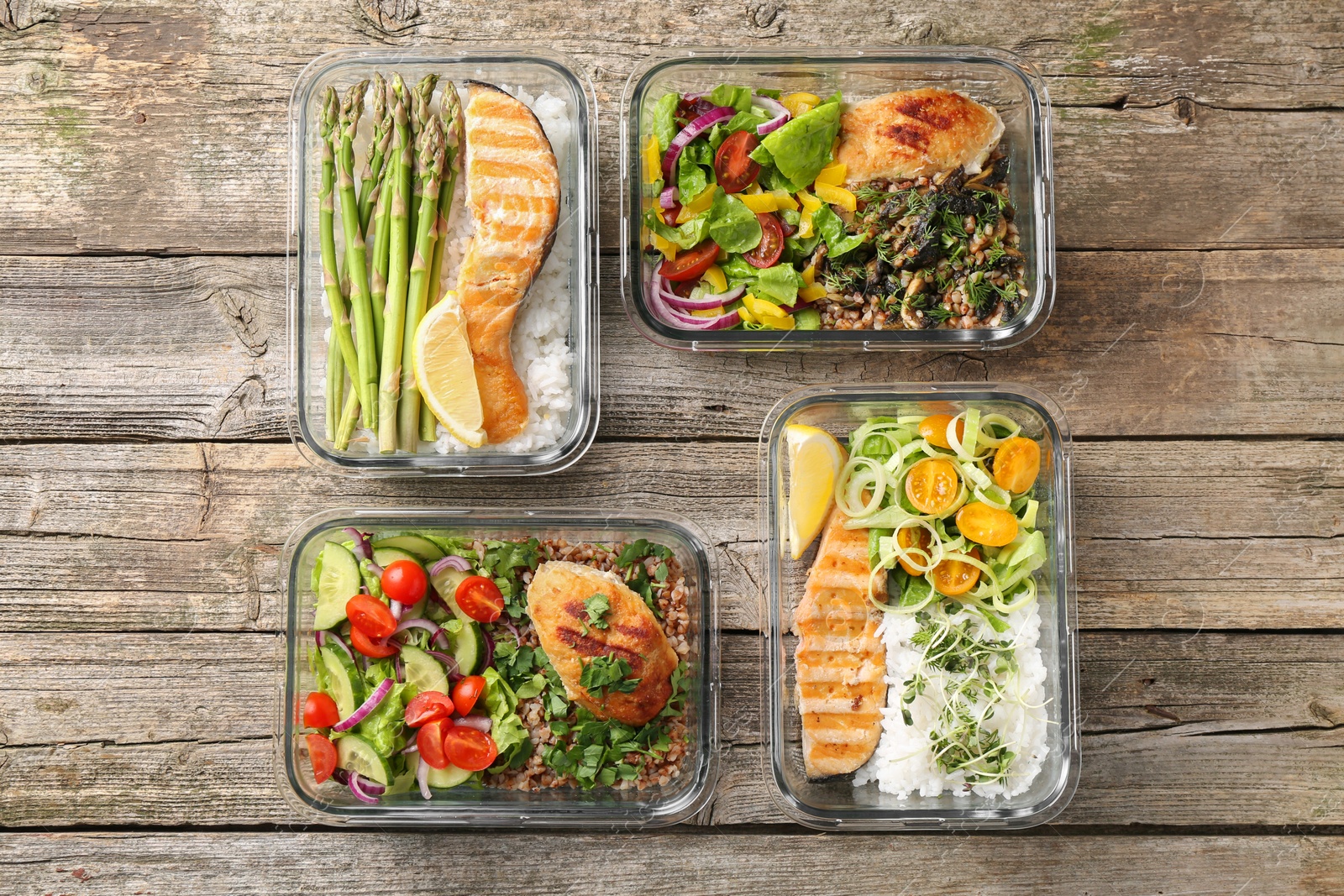 Photo of Healthy meal. Containers with different products on wooden table, flat lay