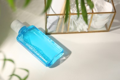 Photo of Bottle of mouthwash on white table in bathroom