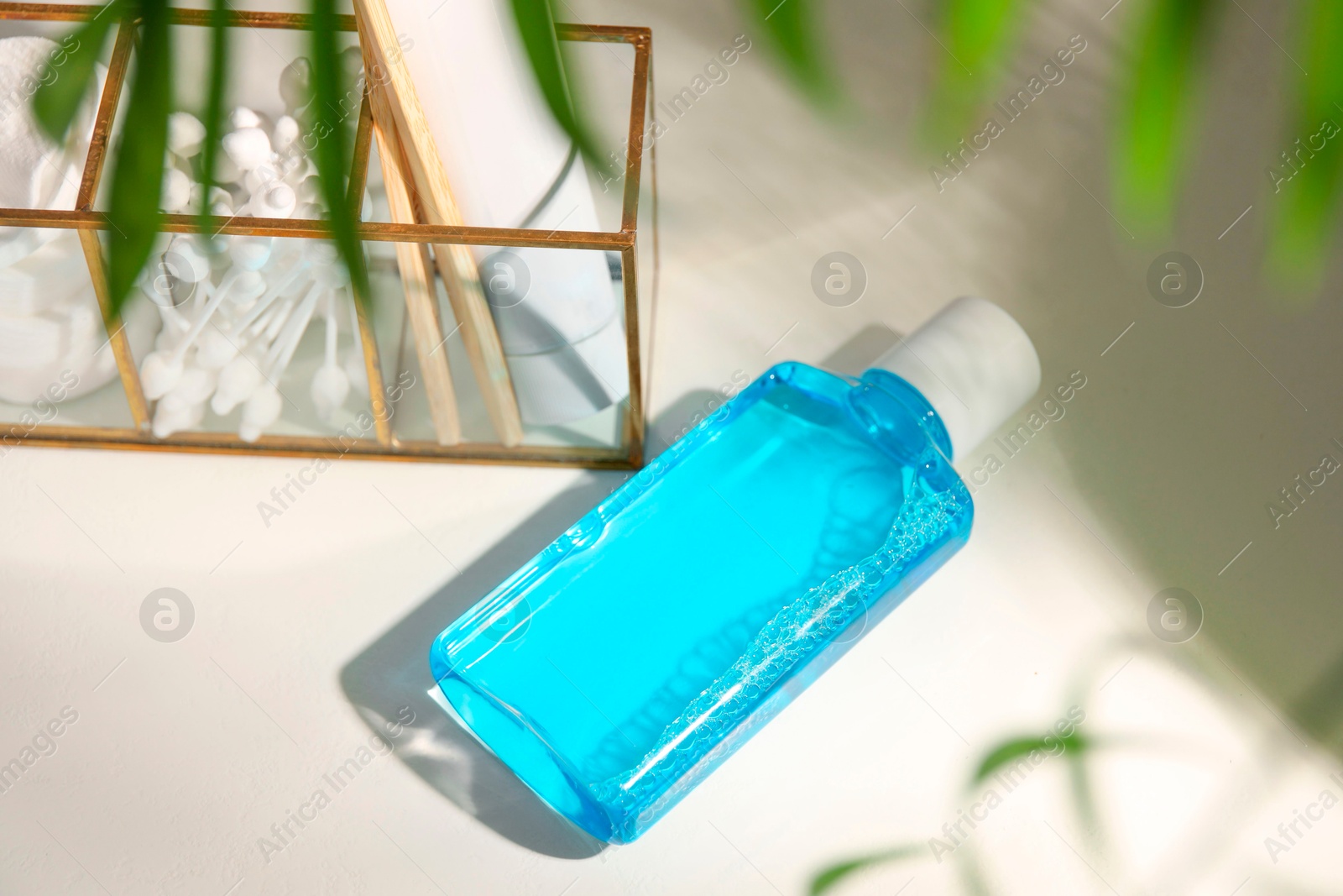 Photo of Bottle of mouthwash on white table in bathroom