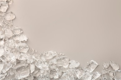 Photo of Pieces of crushed ice on grey background, top view. Space for text