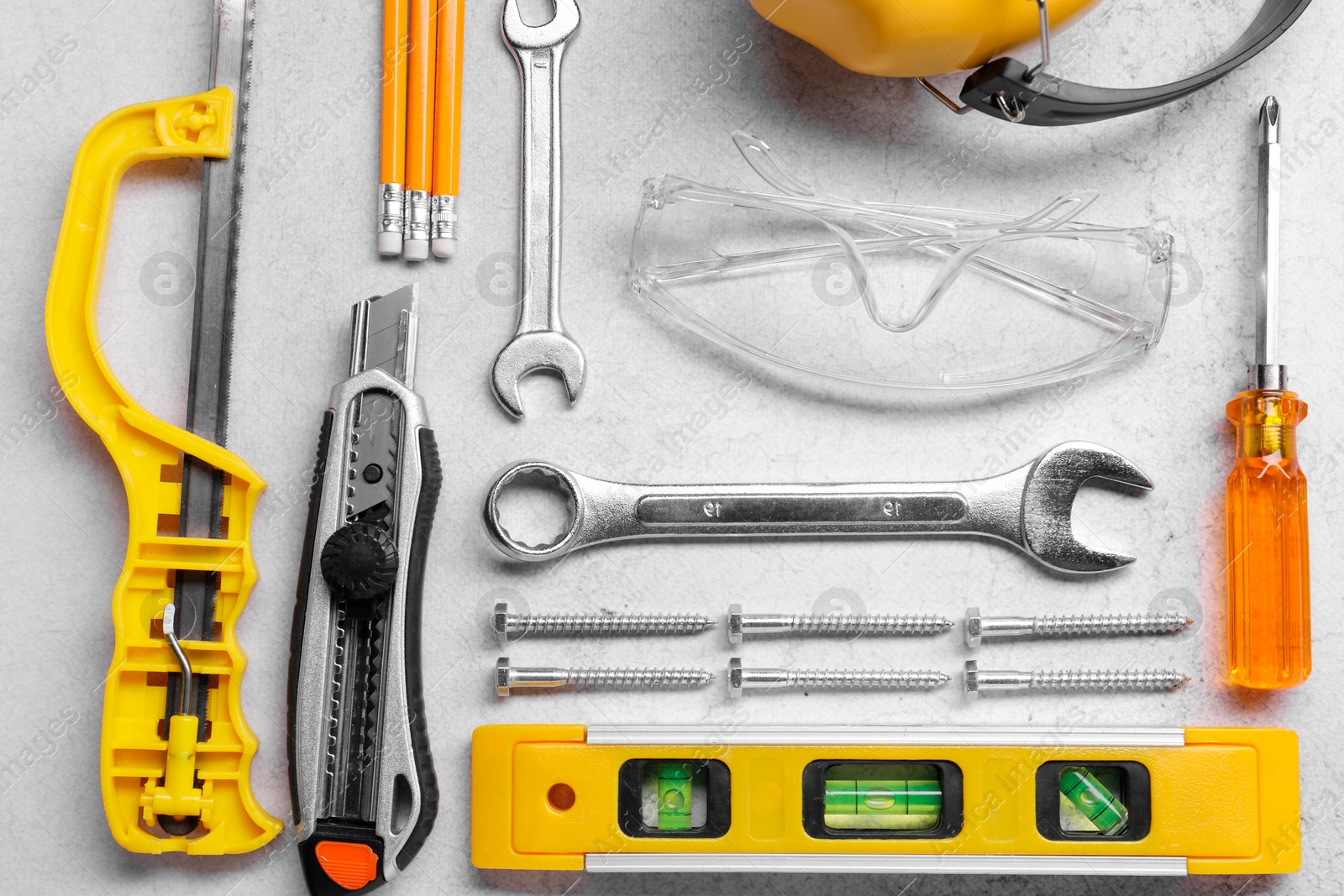 Photo of Flat lay composition with building level and other construction tools on grey table