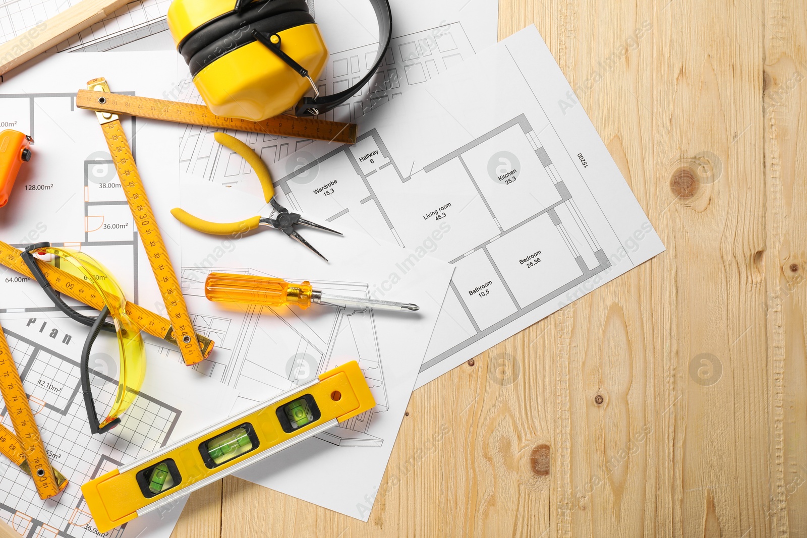 Photo of Flat lay composition with building level and other different construction tools on wooden background, space for text