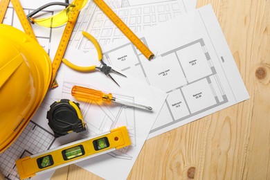 Flat lay composition with building level and other different construction tools on wooden background