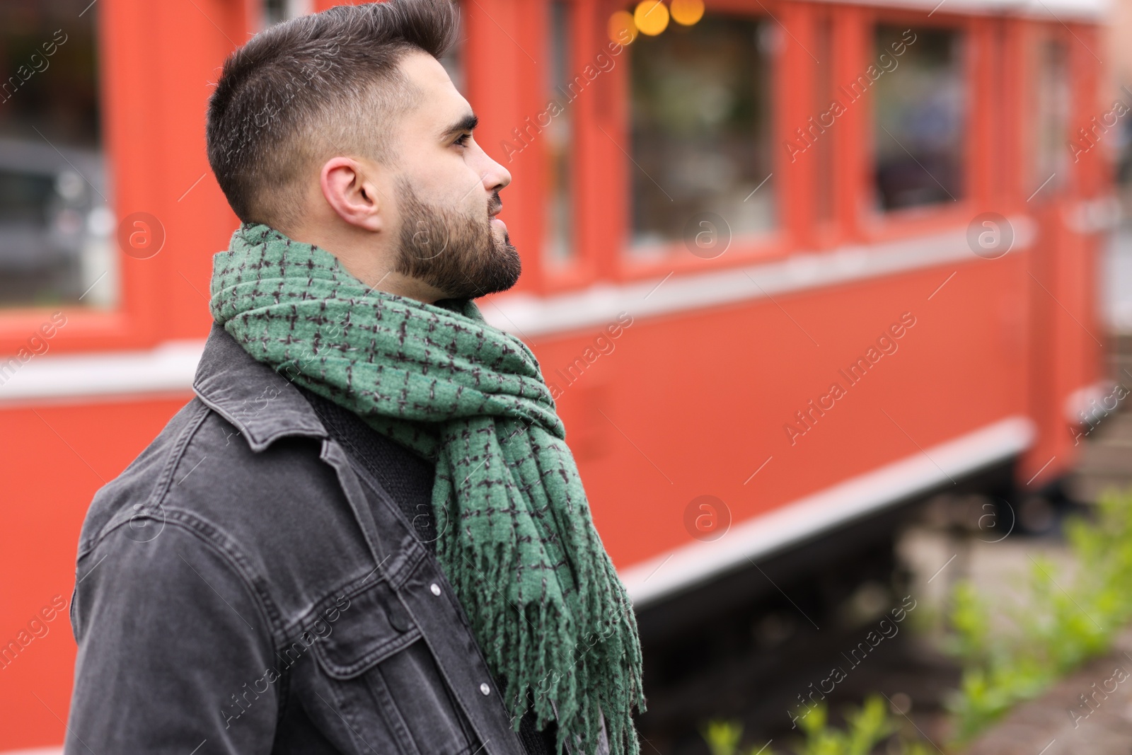 Photo of Man in warm scarf outdoors. Space for text