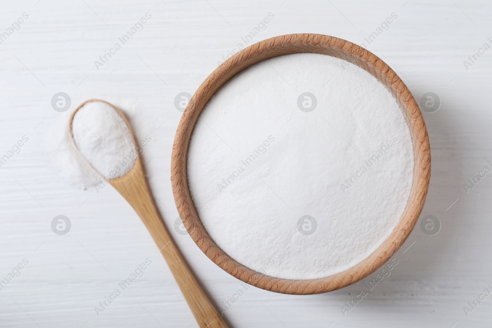 Photo of Baking soda on white wooden table, top view