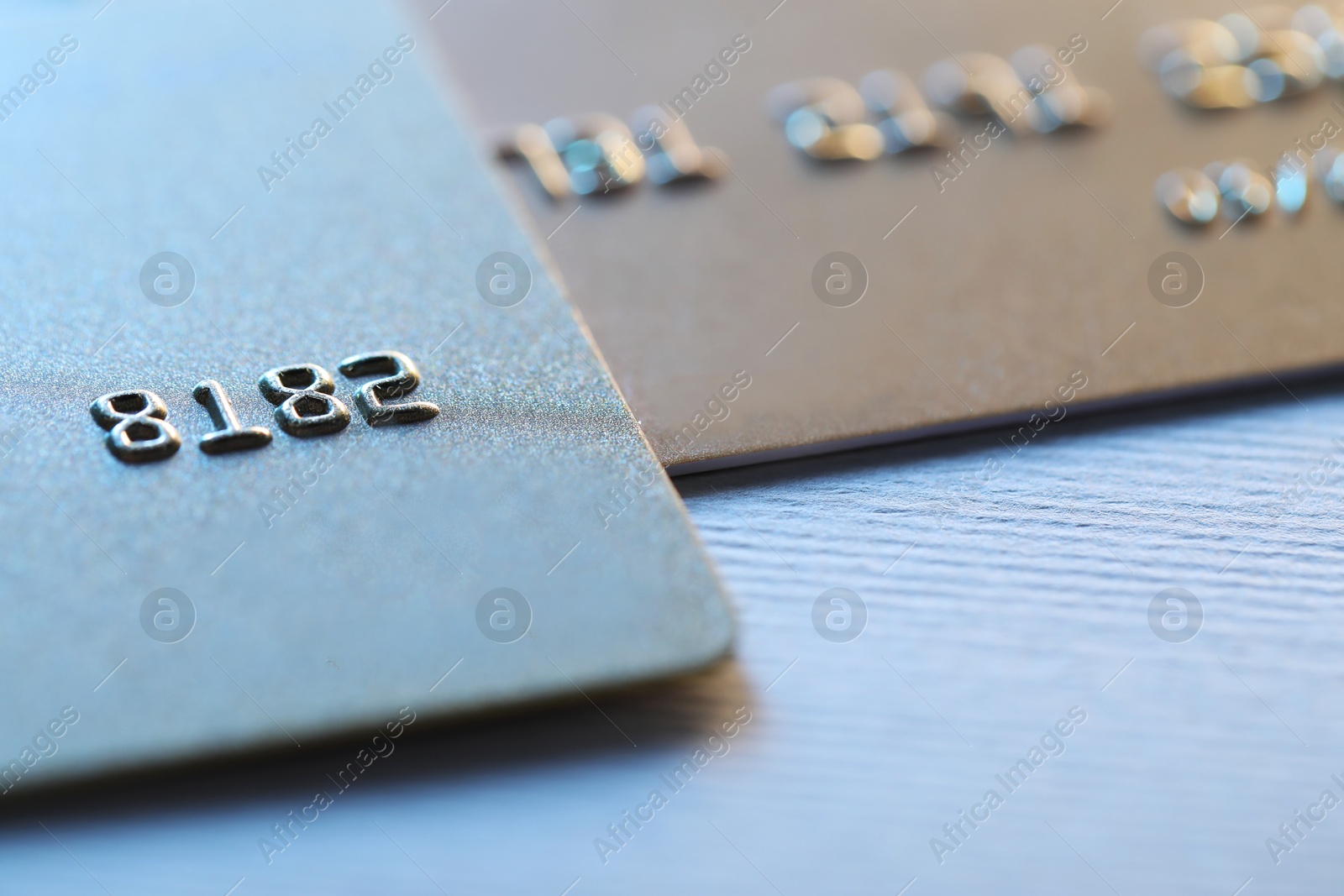 Photo of Two credit cards on light background, closeup