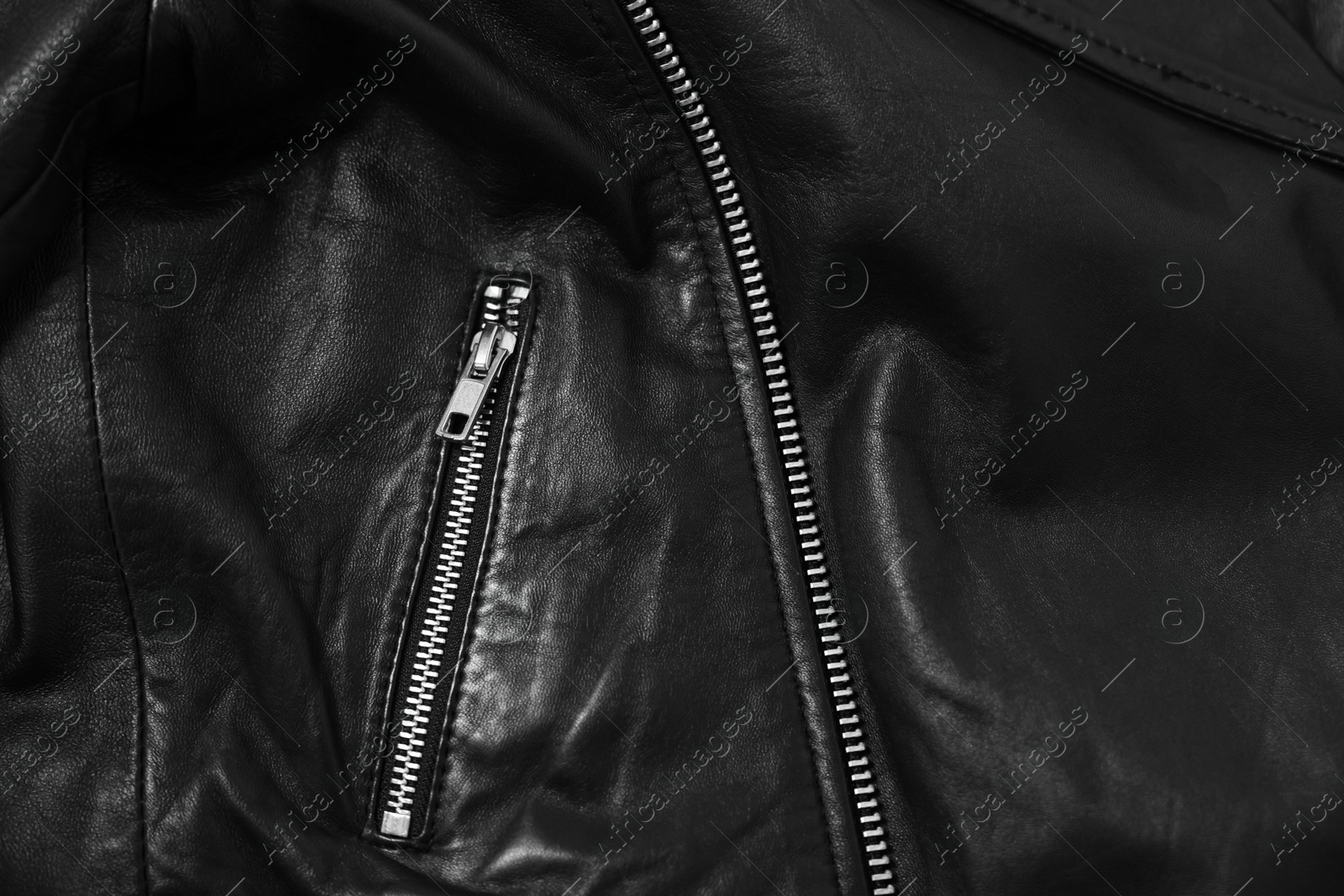 Photo of Texture of black leather jacket with zipper as background, top view