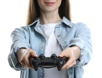 Beautiful woman with controller on white background