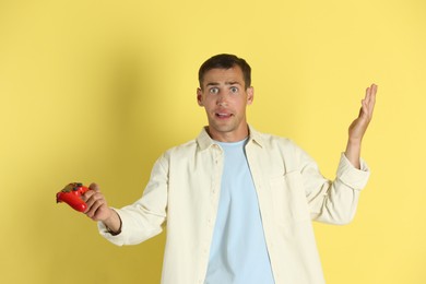 Photo of Emotional man with controller on yellow background