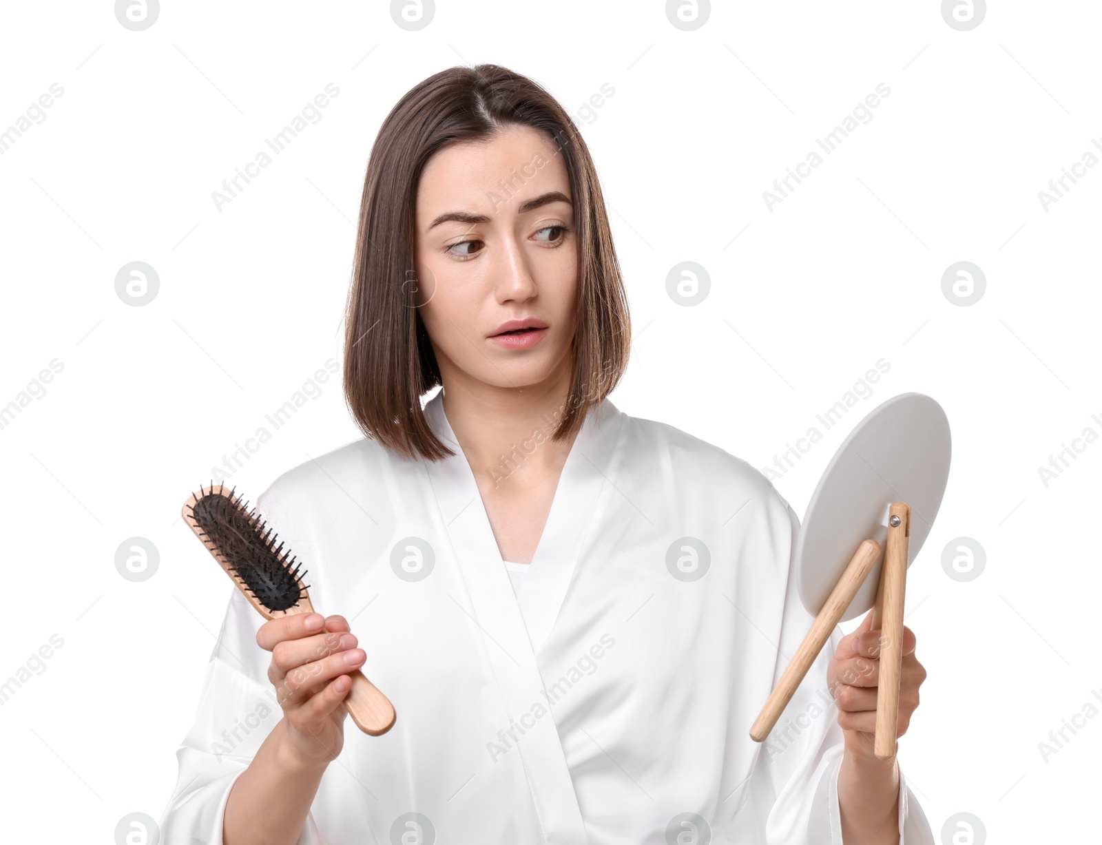 Photo of Young woman with hair loss problem looking at mirror on white background