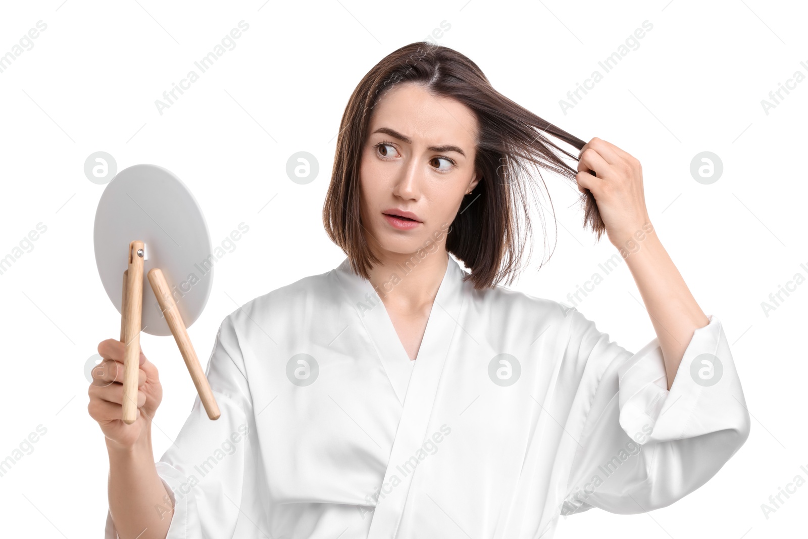 Photo of Sad woman with hair loss problem looking at mirror on white background