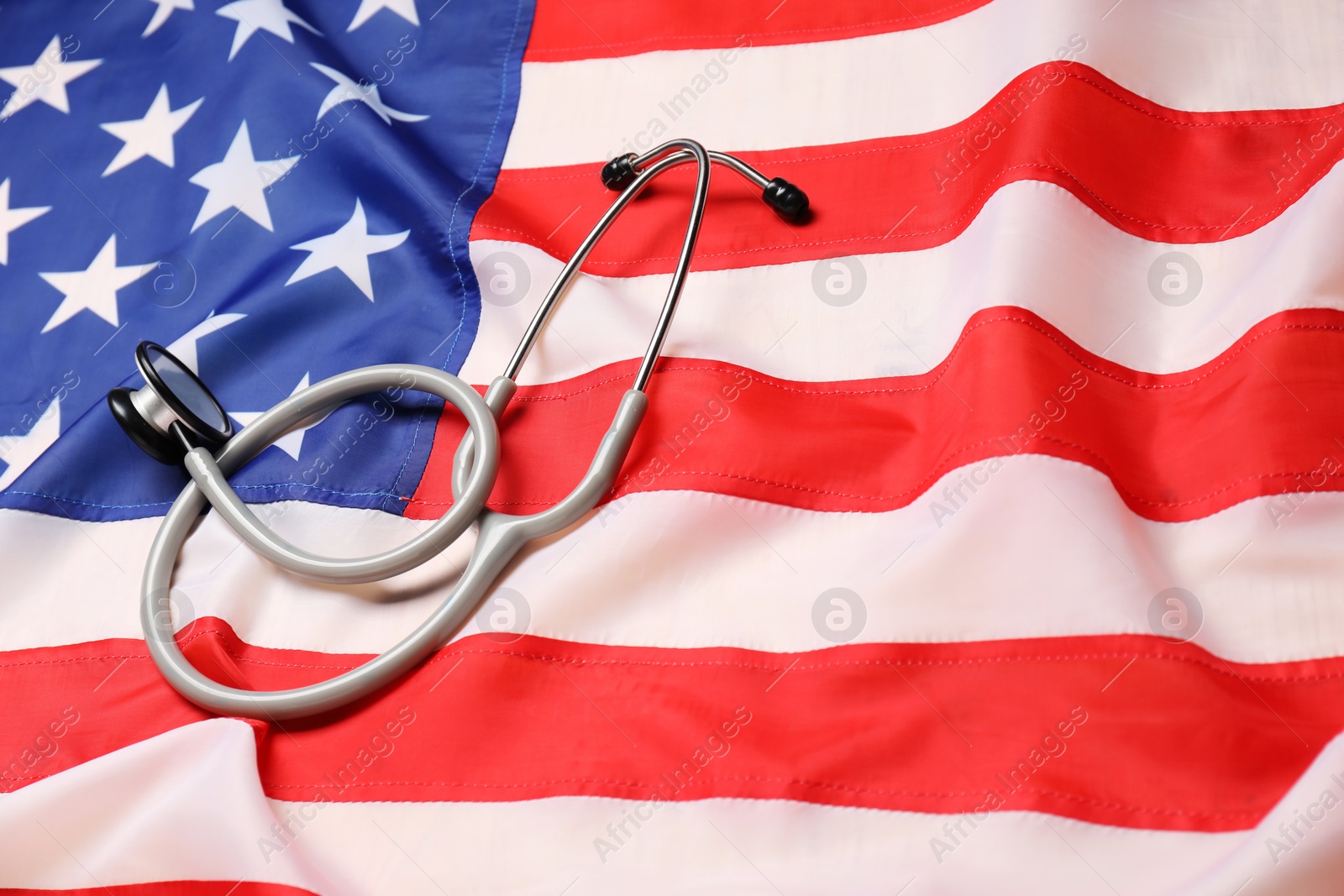 Photo of Stethoscope on USA flag, closeup. Health care concept