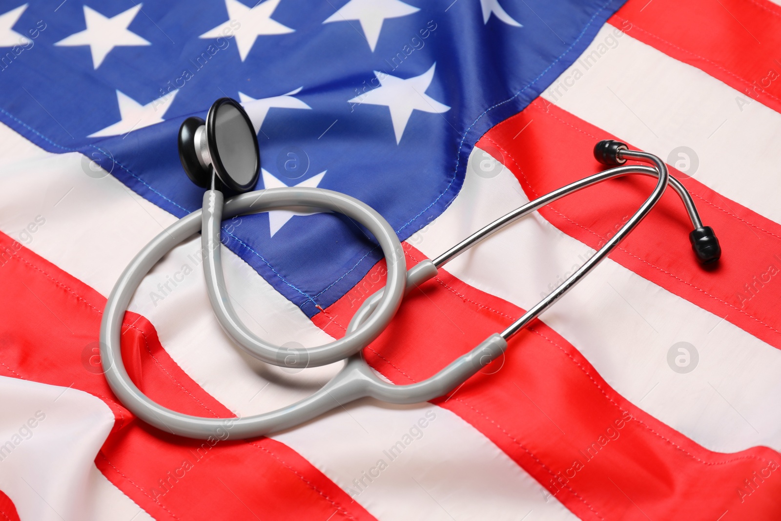 Photo of Stethoscope on USA flag, closeup. Health care concept