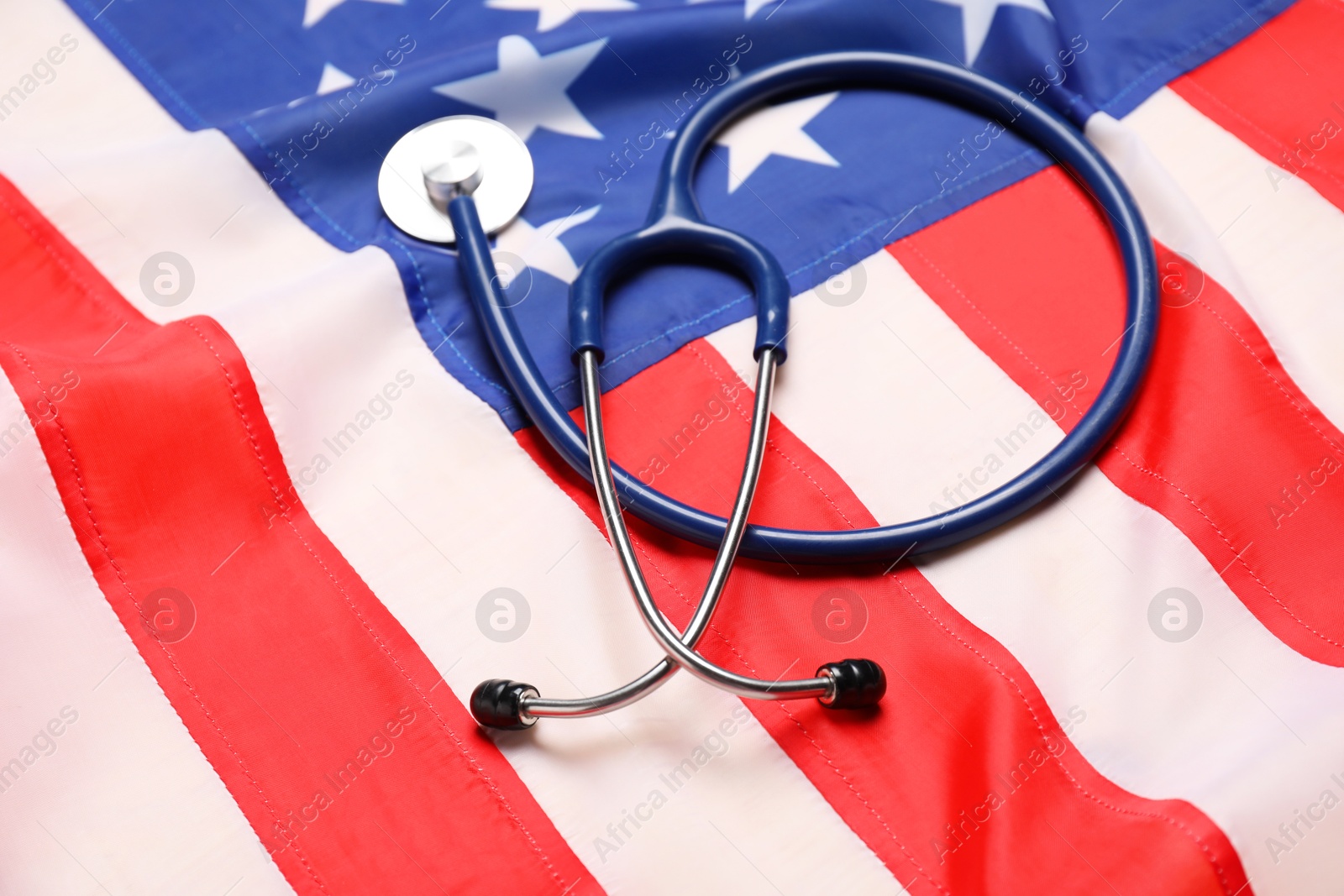 Photo of Stethoscope on USA flag, closeup. Health care concept