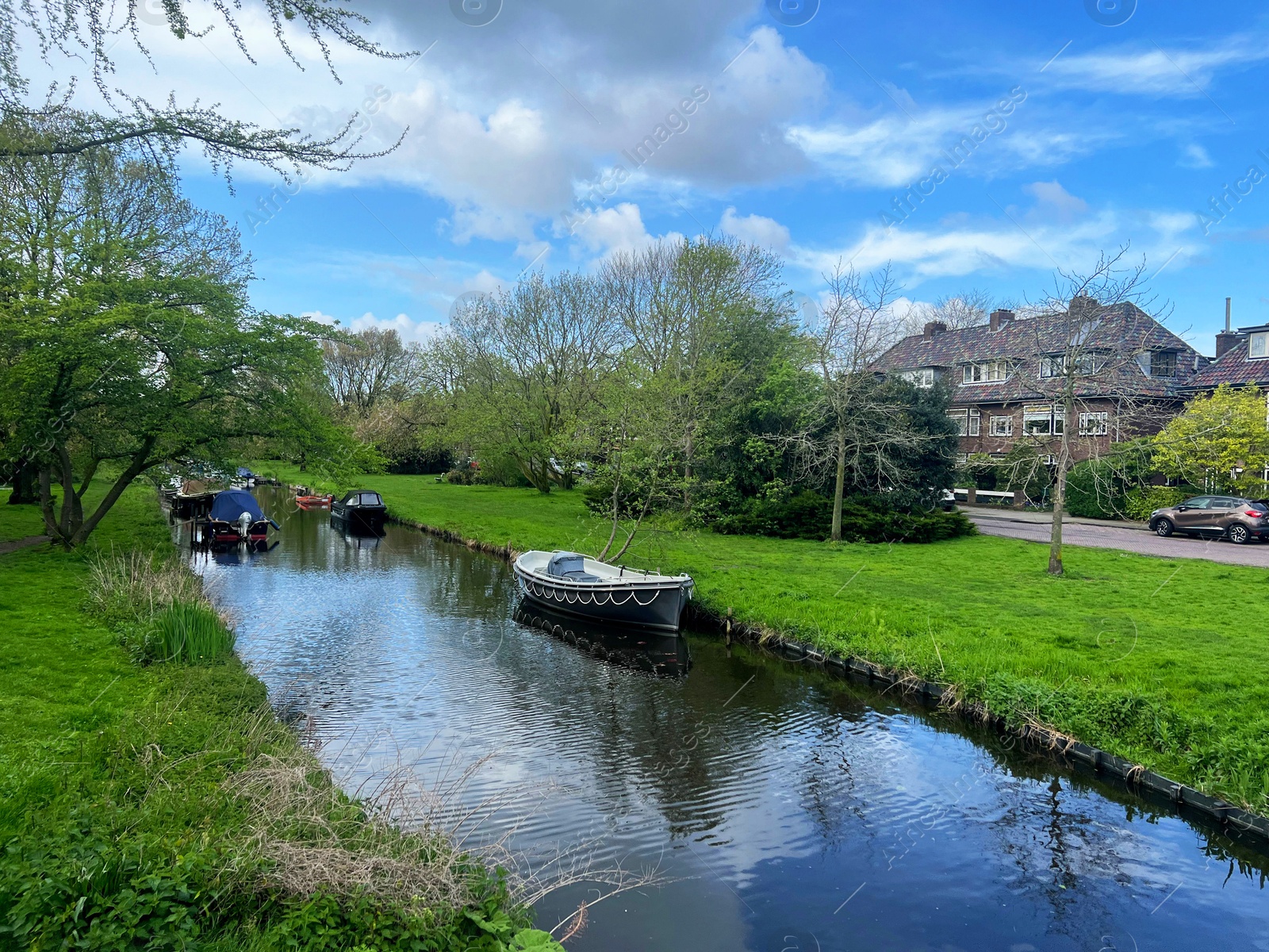 Photo of Canal with moored boats on sunny day