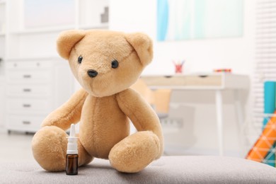 Photo of Toy cute bear with nasal spray indoors, space for text