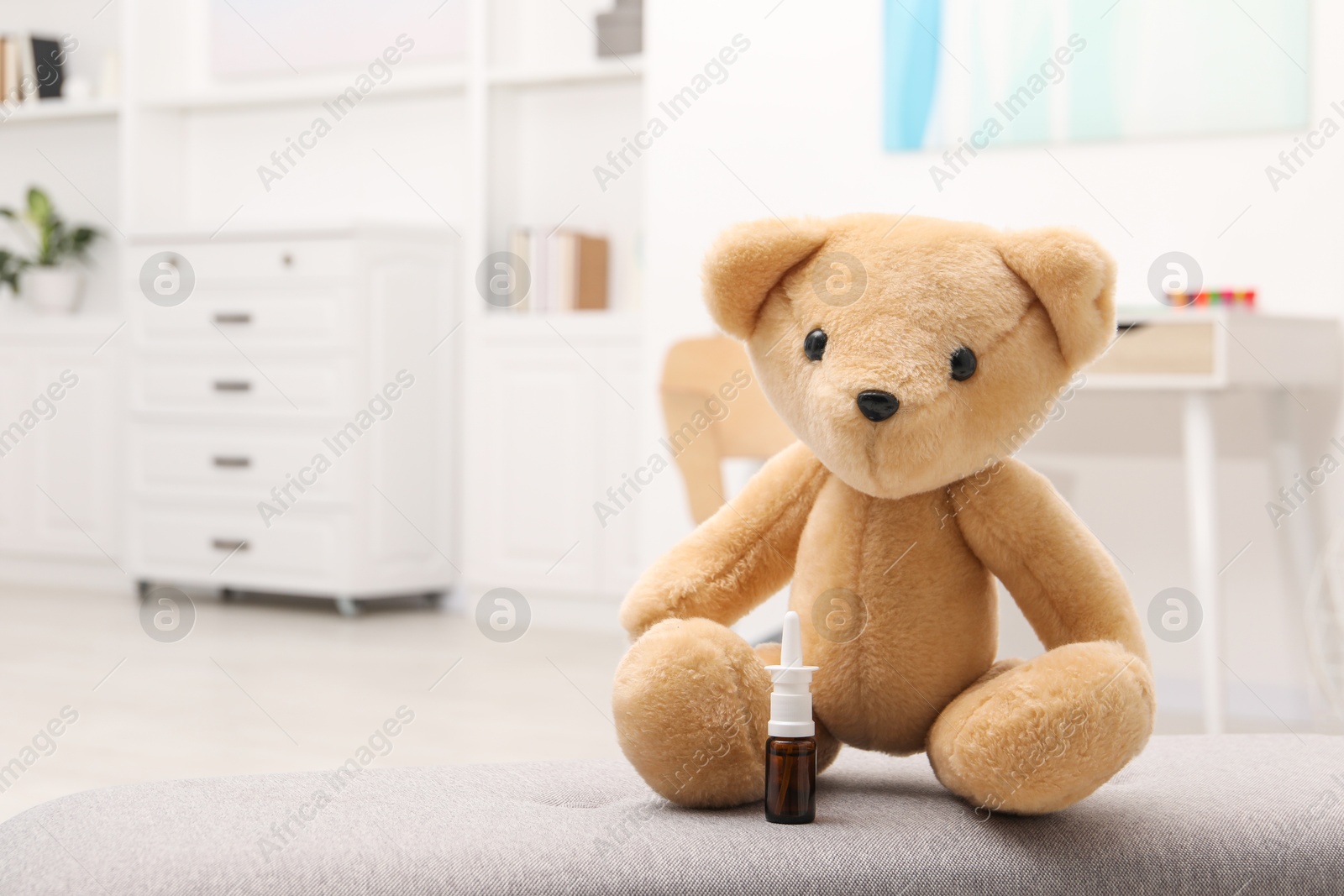Photo of Toy cute bear with nasal spray indoors, space for text