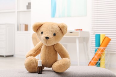 Toy cute bear with nasal spray indoors