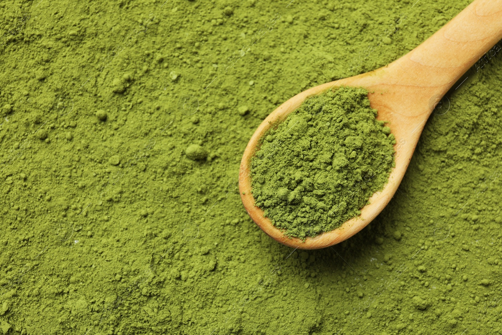 Photo of Spoon and green matcha powder, top view