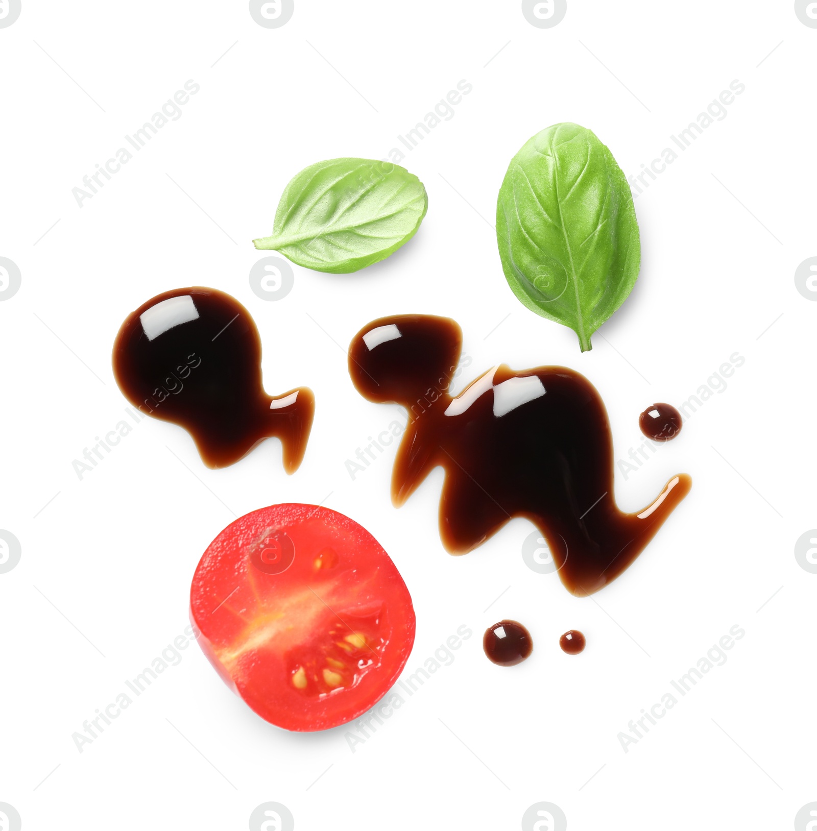 Photo of Delicious balsamic vinegar, cut tomato and basil isolated on white, top view