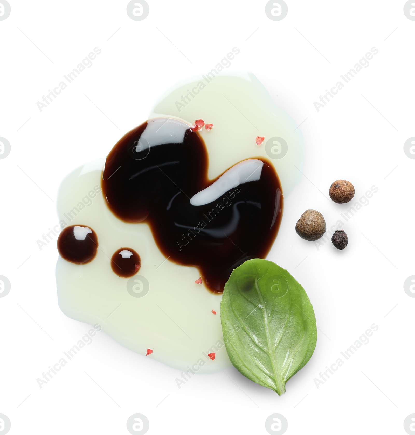 Photo of Delicious balsamic vinegar with olive oil, basil and peppercorns isolated on white, top view