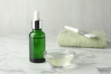 Photo of Bowl and bottle of chemical peel on white marble table. Peeling procedure