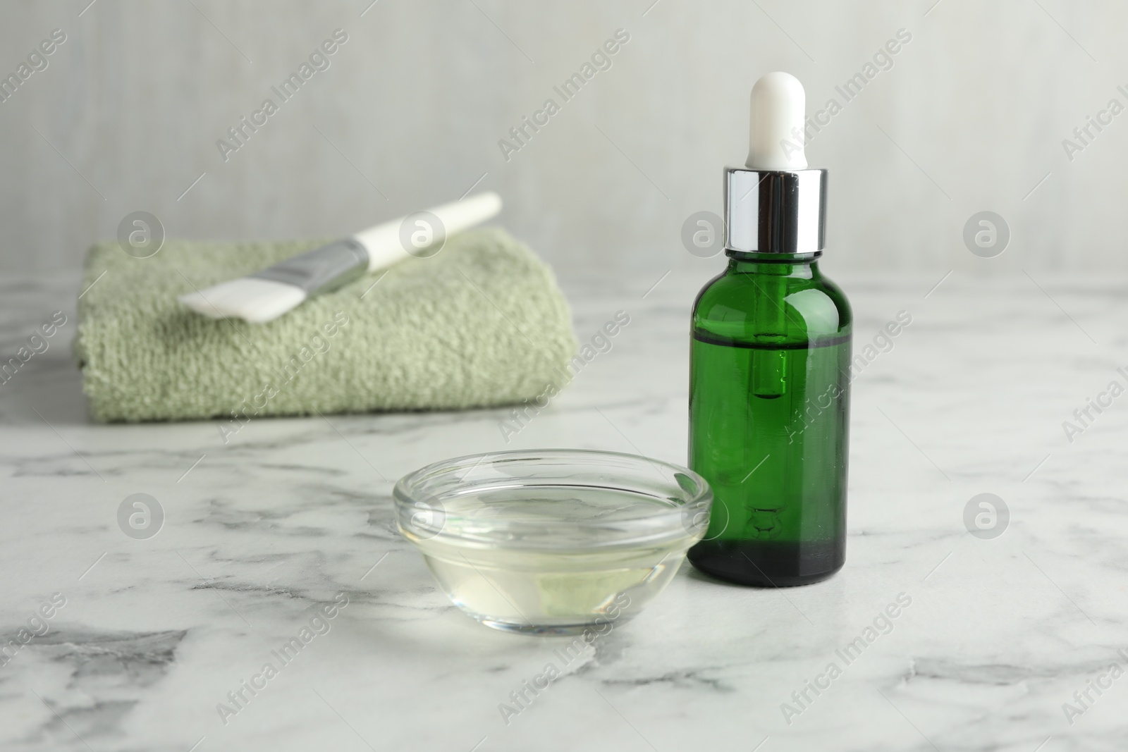 Photo of Bowl and bottle of chemical peel on white marble table. Peeling procedure