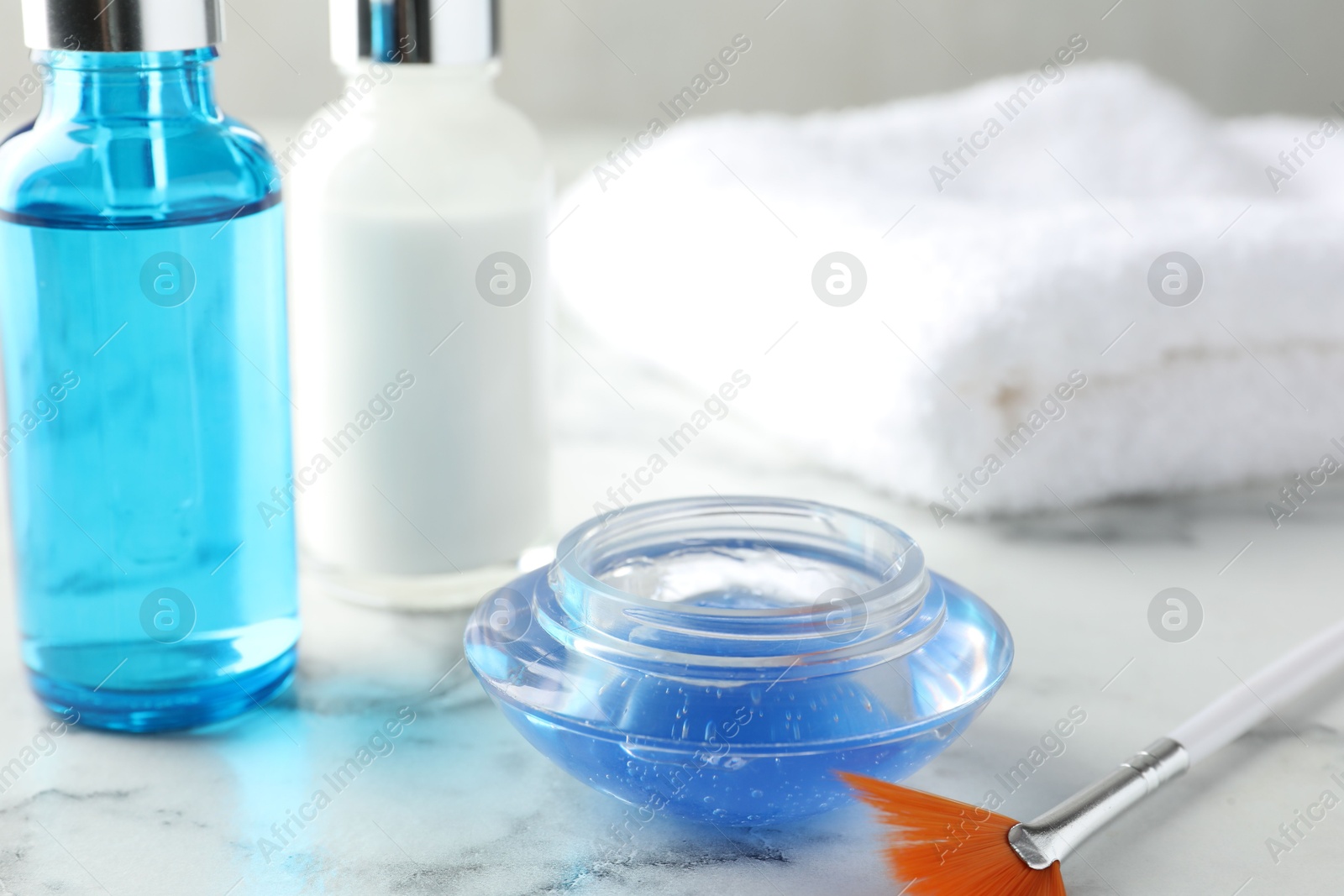 Photo of Chemical peel and brush on white marble table, closeup. Peeling procedure