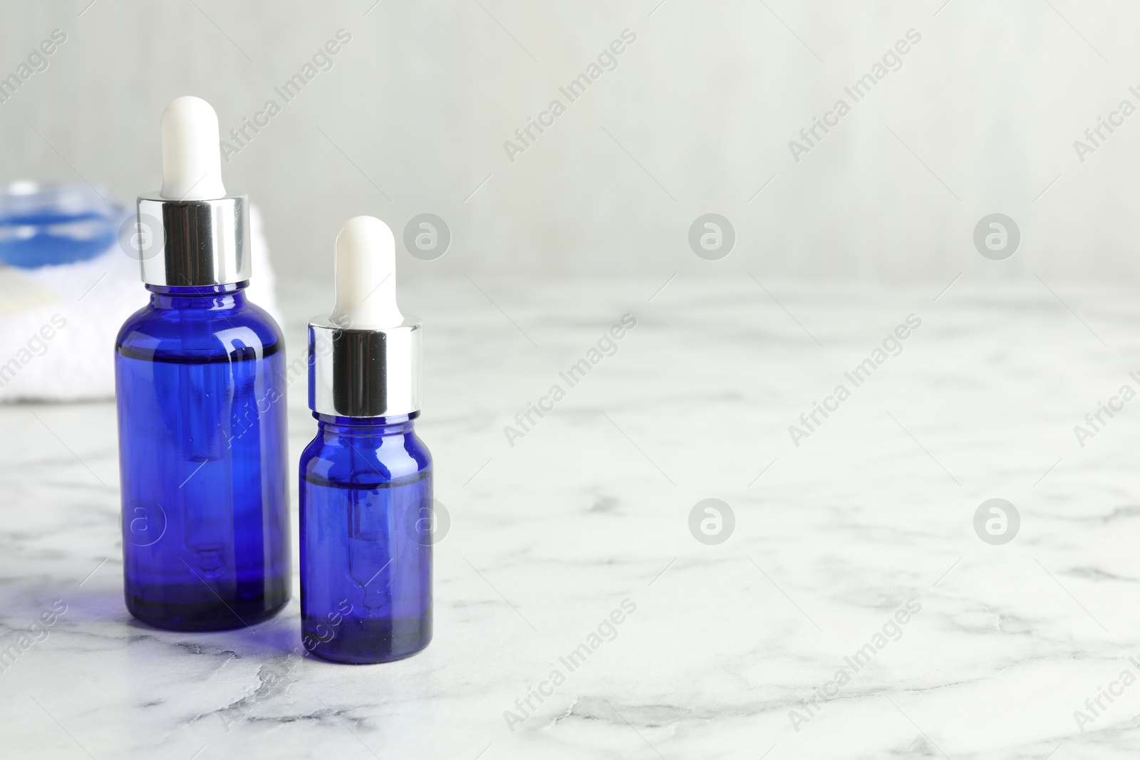 Photo of Bottles of chemical peel on white marble table, space for text. Peeling procedure