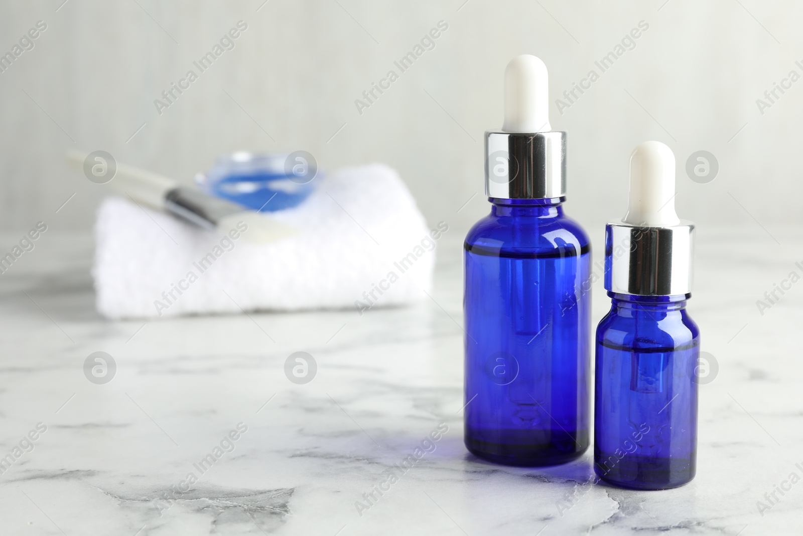 Photo of Bottles of chemical peel on white marble table, space for text. Peeling procedure