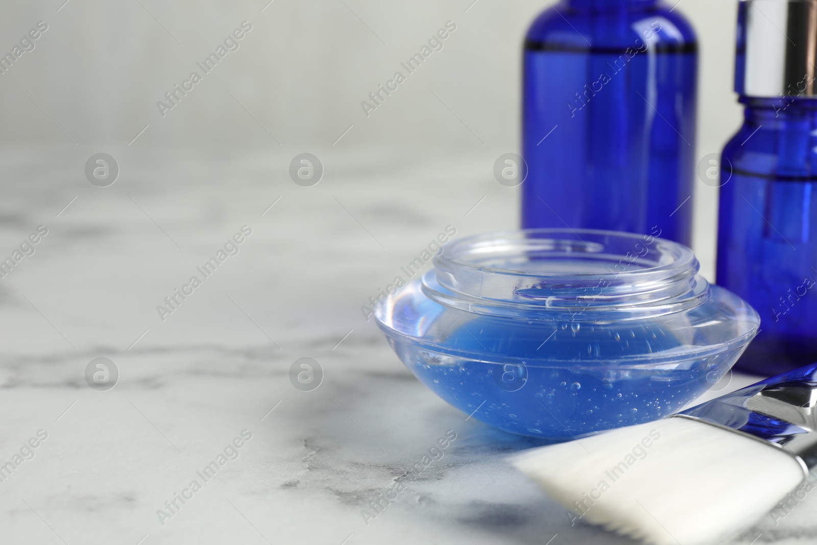 Photo of Chemical peel and brush on white marble table, closeup with space for text. Peeling procedure