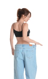 Woman in big jeans showing her slim body on white background
