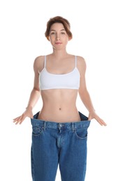 Woman in big jeans showing her slim body on white background
