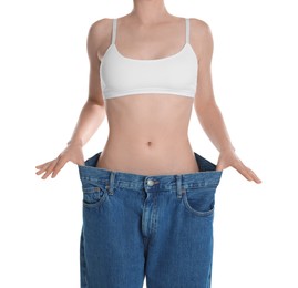 Photo of Woman in big jeans showing her slim body on white background, closeup