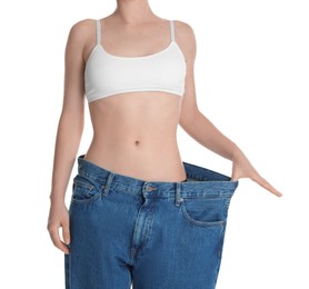 Woman in big jeans showing her slim body on white background, closeup