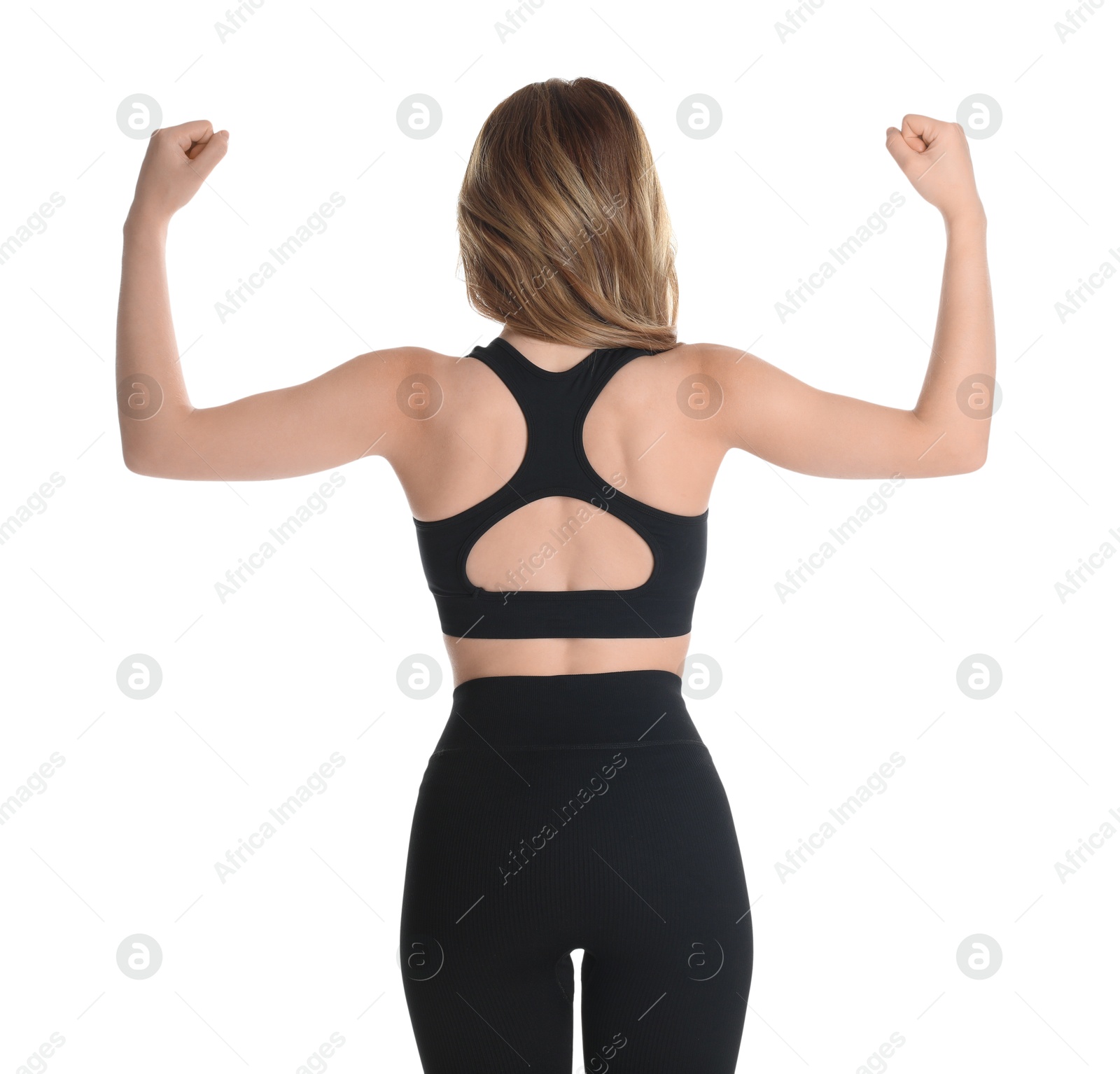 Photo of Woman with slim body showing muscles on white background, back view