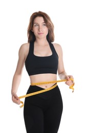 Woman with measuring tape showing her slim body against white background