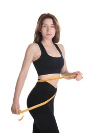 Woman with measuring tape showing her slim body against white background