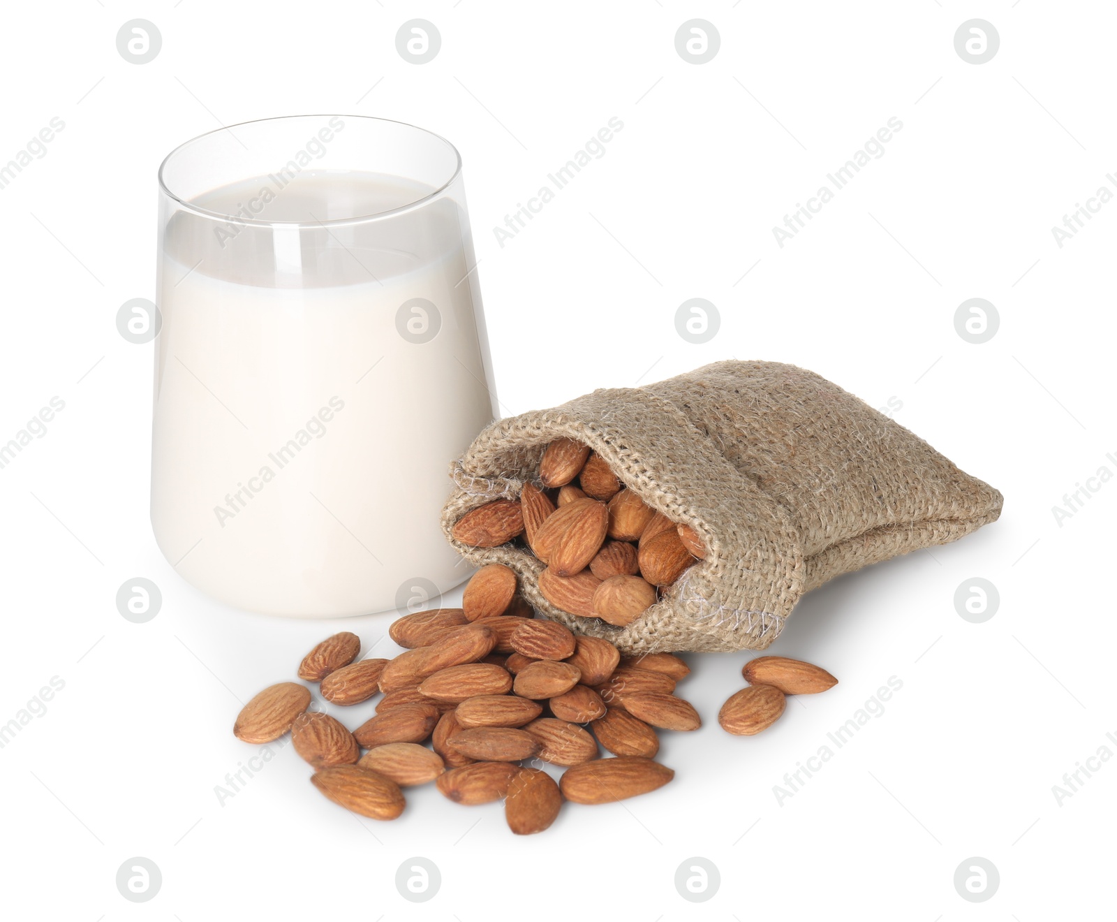 Photo of Glass of almond milk and almonds isolated on white