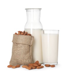 Photo of Glass of almond milk, jug and almonds isolated on white