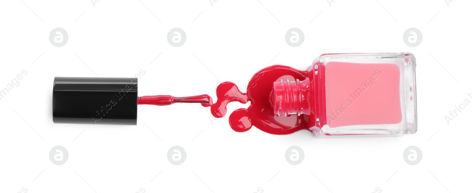 Photo of Bottle, brush and spilled red nail polish isolated on white, top view