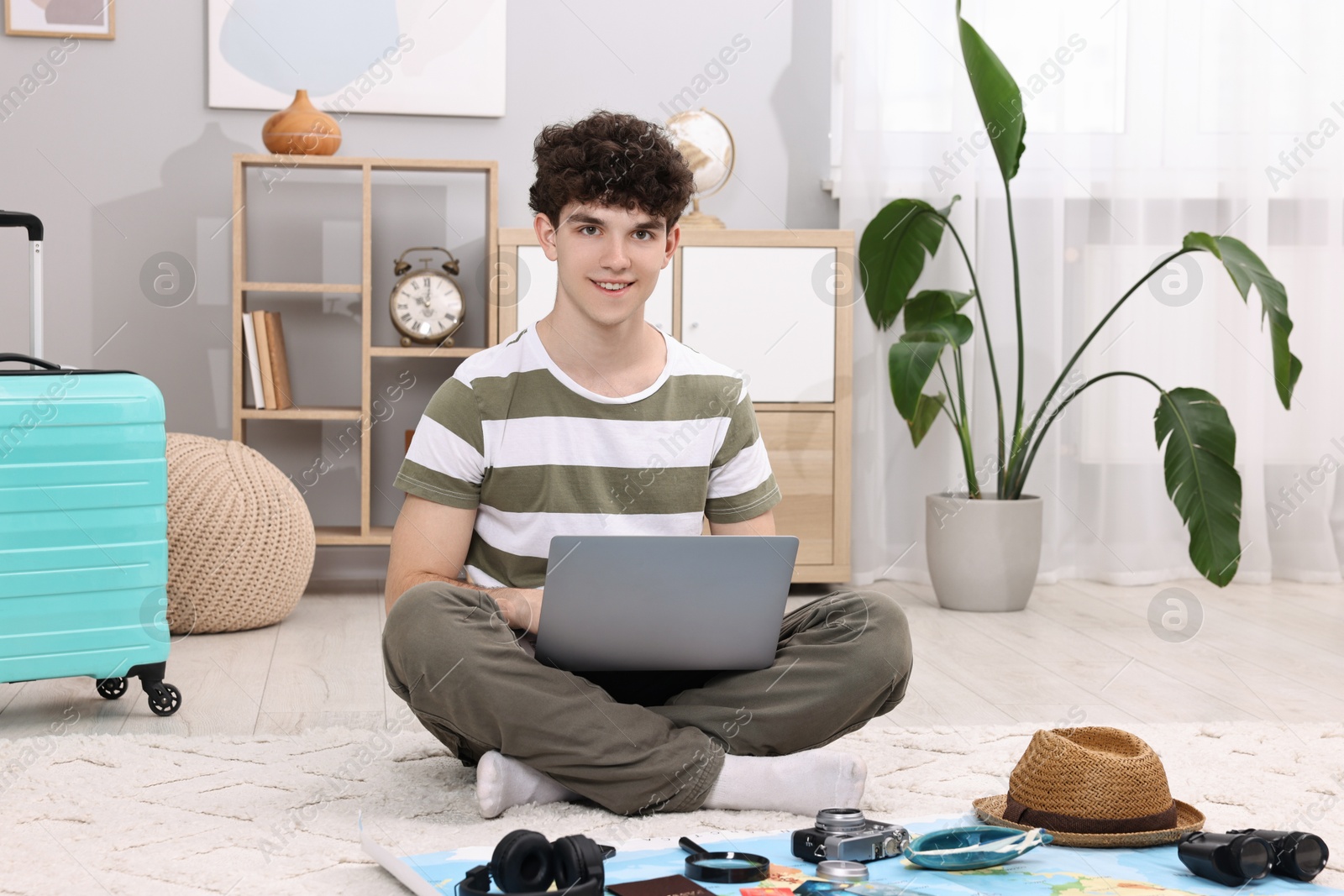 Photo of Travel blogger using laptop for planning trip at home